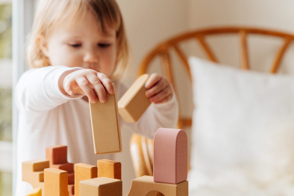 toddler playing with blocks image for post on children's developmental milestones